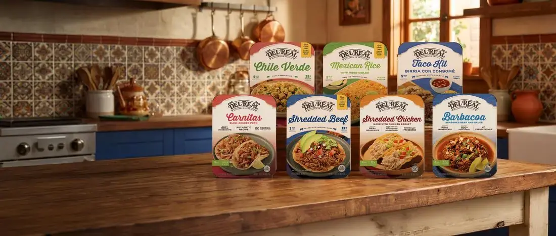 Del Real Foods complete product lineup: 8 products including Carnitas, Shredded Beef, Shredded Chicken, Barbacoa, Chile Verde, Mexican Rice, and Taco Kit in a warm rustic kitchen